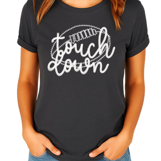 Black women's football graphic tee flat lay showing shirt design and cut