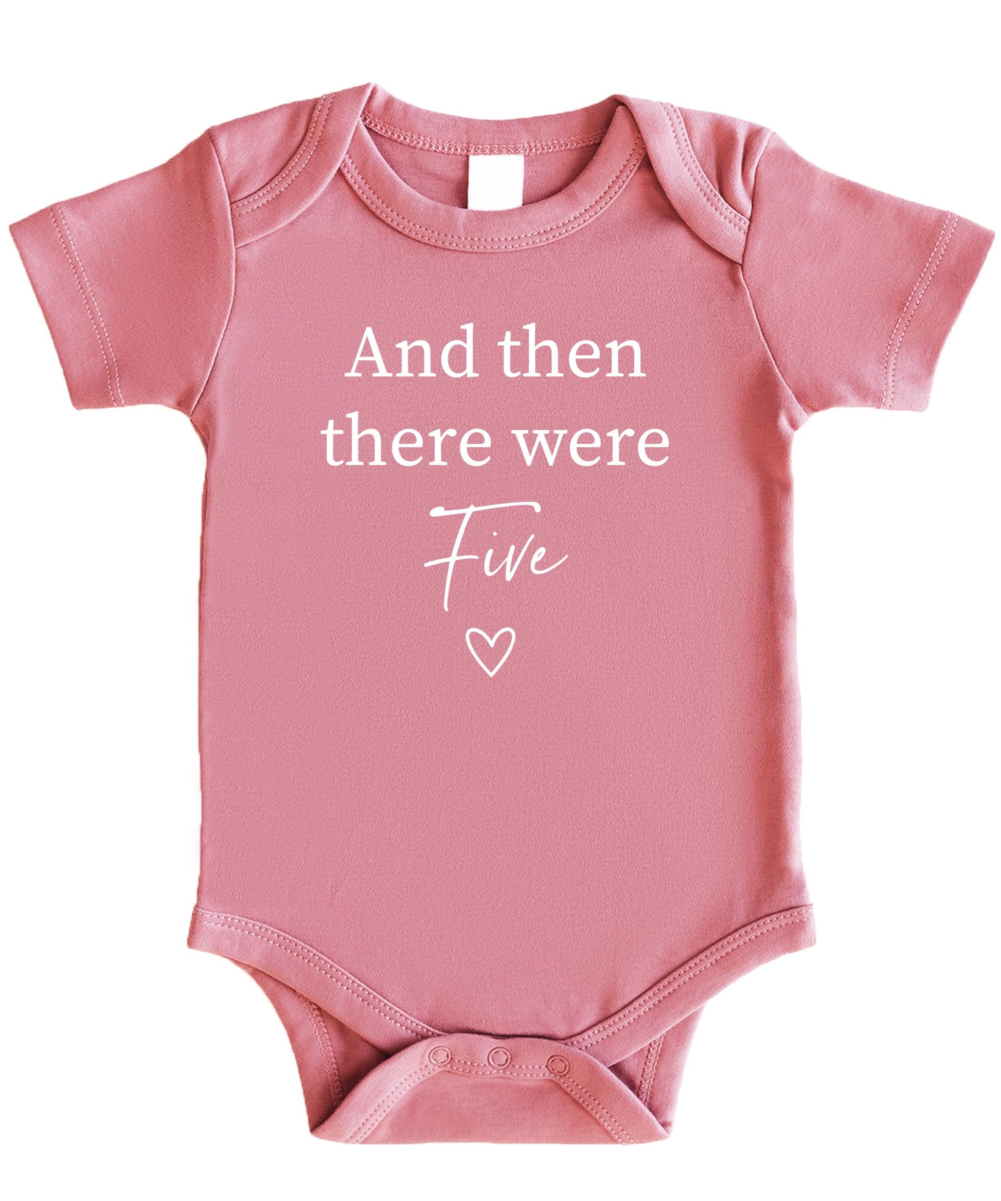 Close-up of And Then There Were 4 heart graphic on mauve baby bodysuit for sibling reveal