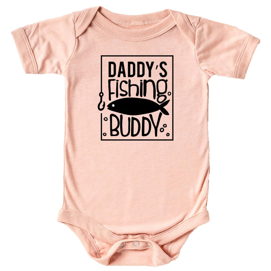Close-up of Daddy's Fishing Buddy print on peach baby bodysuit showing bold graphic detail