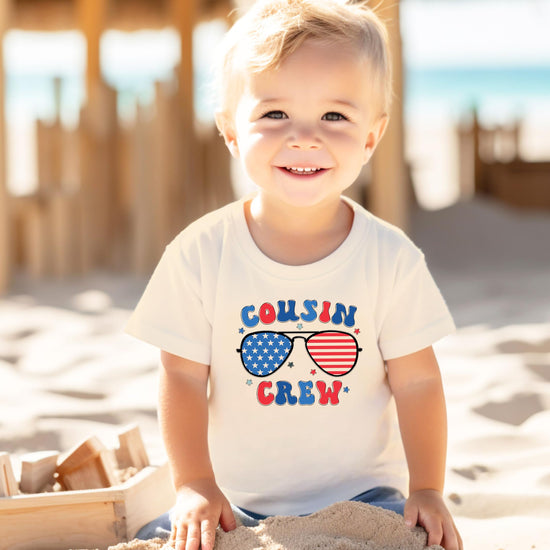 Youth wearing peach Cousin Crew patriotic t-shirt showing fit and style