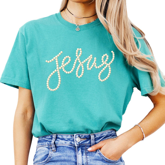 Side or lifestyle view of women wearing seafoam Jesus pearl script graphic tee
