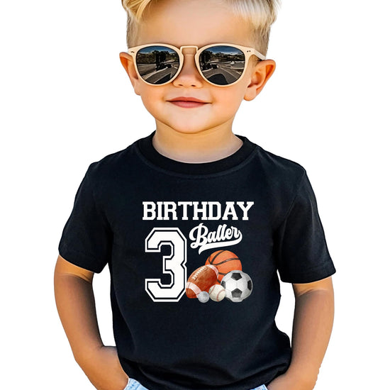 Boys wearing Birthday Baller sports graphic tee for third birthday party