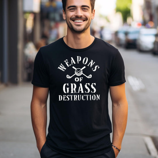 Flat lay of black golf graphic tee showing full design details