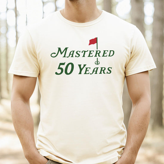 Back view of Mastered 50 Years funny golf tee in vintage green