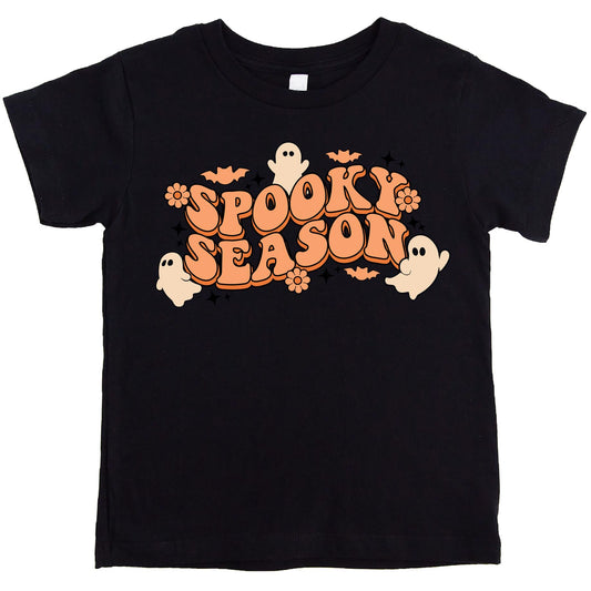 Detail shot of spooky season groovy ghosts design on purple youth girls Halloween shirt