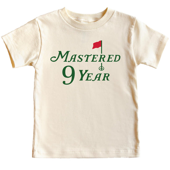 Youth golf birthday tee laid flat showing full graphic design in natural colorway