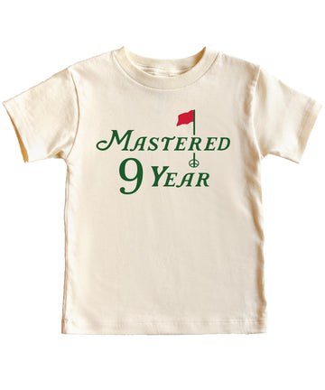 Youth golf birthday tee laid flat showing full graphic design in natural colorway
