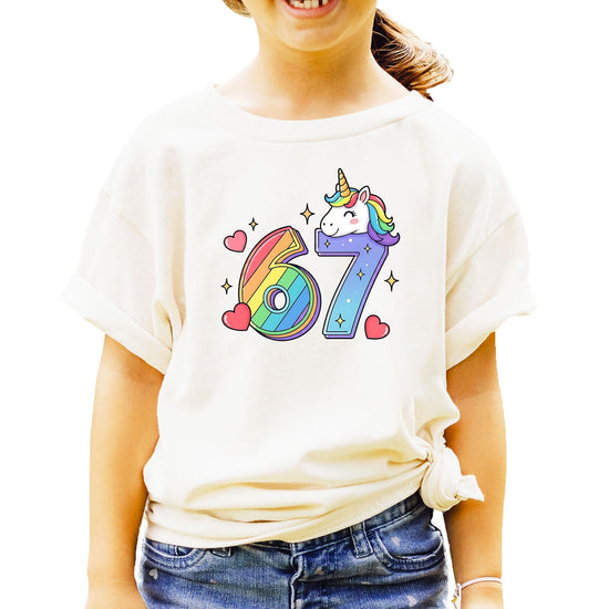 Natural colored unicorn birthday shirt flat lay showing full I Was 6 Now I'm 7 rainbow design