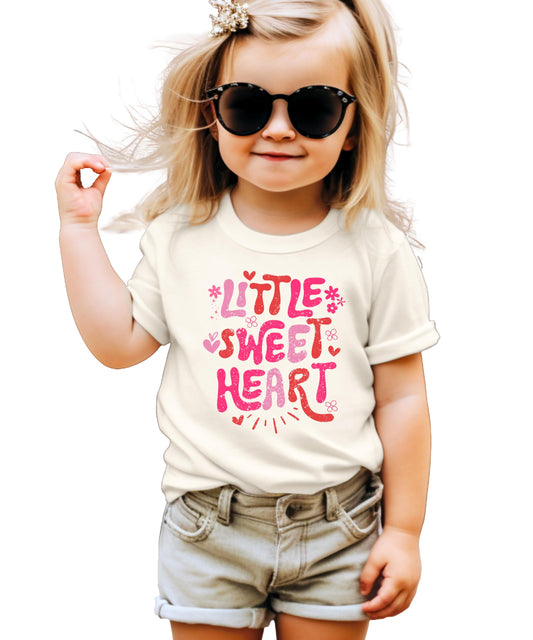 Close-up of Little Sweet Heart graphic print on pink girls t-shirt
