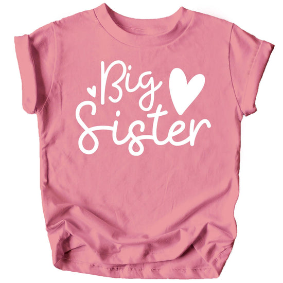Toddler girl wearing pink Big Sister Hearts sibling reveal shirt from Olive Loves Apple