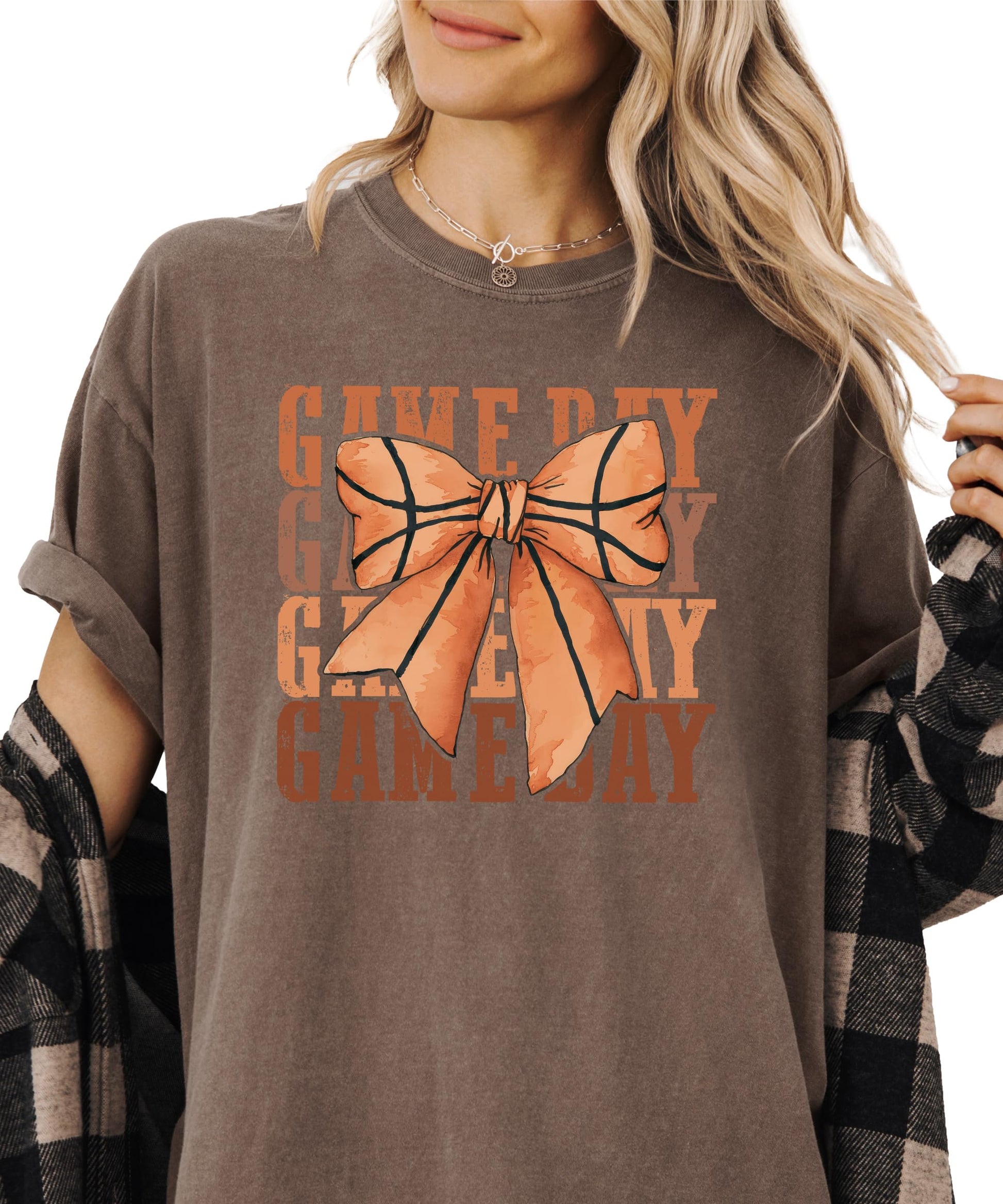 Close-up view of coquette bow basketball graphic on women's tee