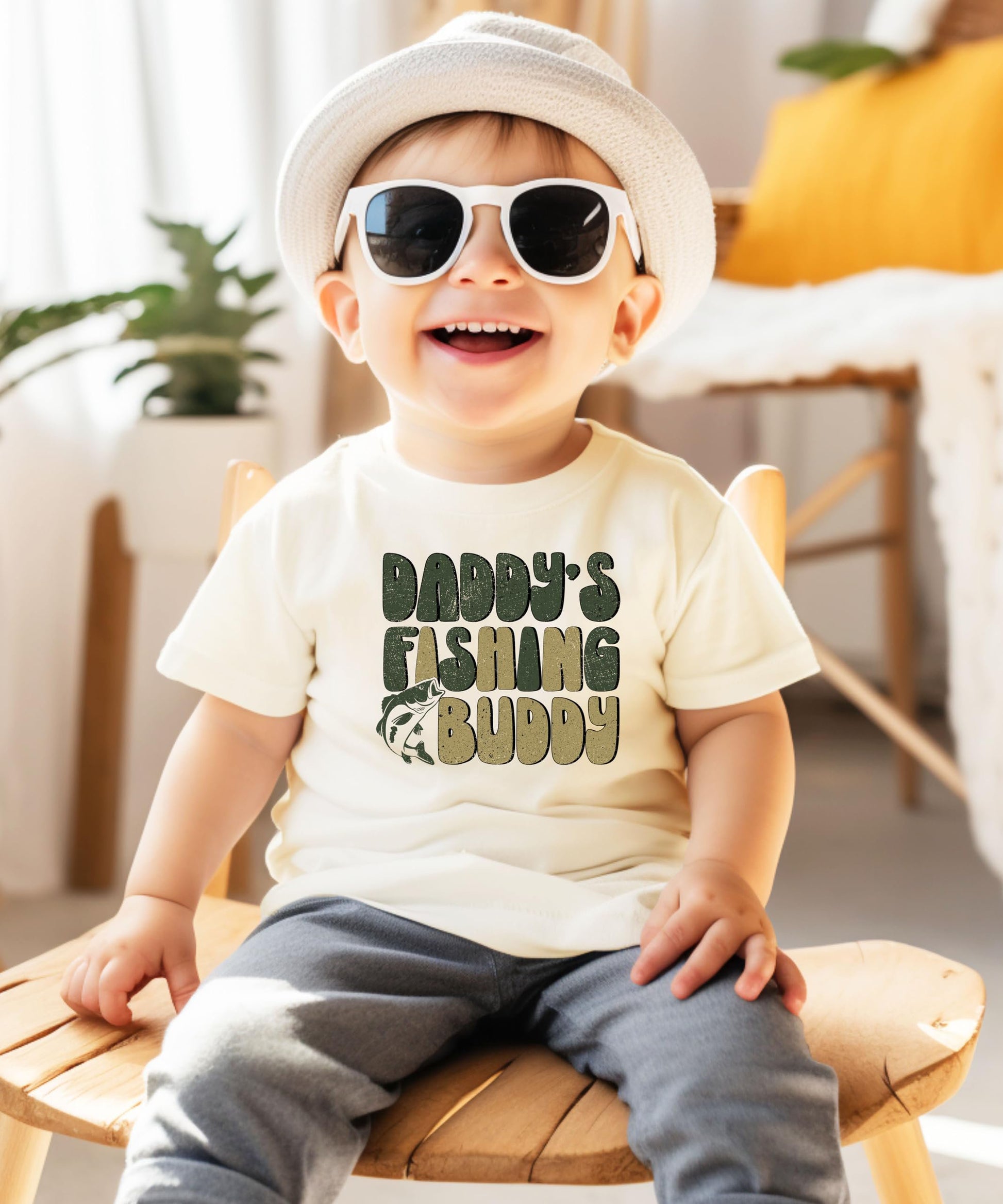 Front view of kids fishing graphic t-shirt laid flat on natural background