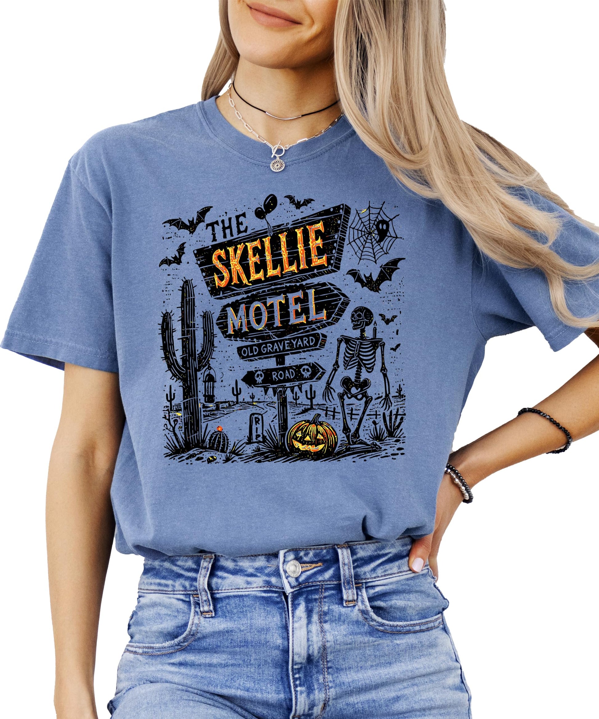 Back or side view of Skellie Motel spooky skeleton Halloween shirt in seafoam color