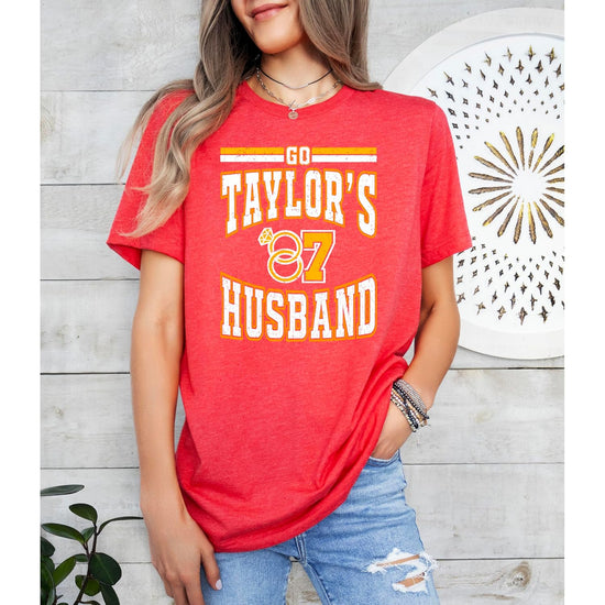 Girl wearing Go Taylor's Husband youth graphic tee in vintage red for football game day