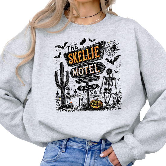 Side or lifestyle view of The Skellie Hotel spooky Halloween graphic crewneck sweatshirt