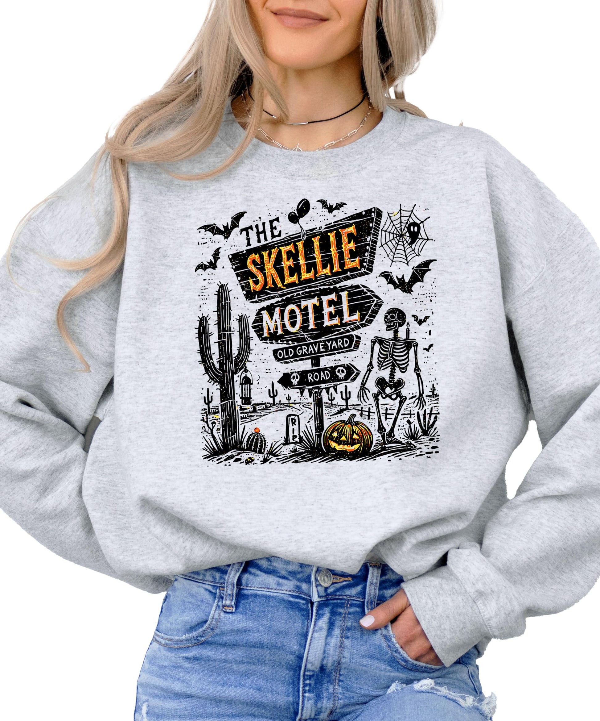 Side or lifestyle view of The Skellie Hotel spooky Halloween graphic crewneck sweatshirt
