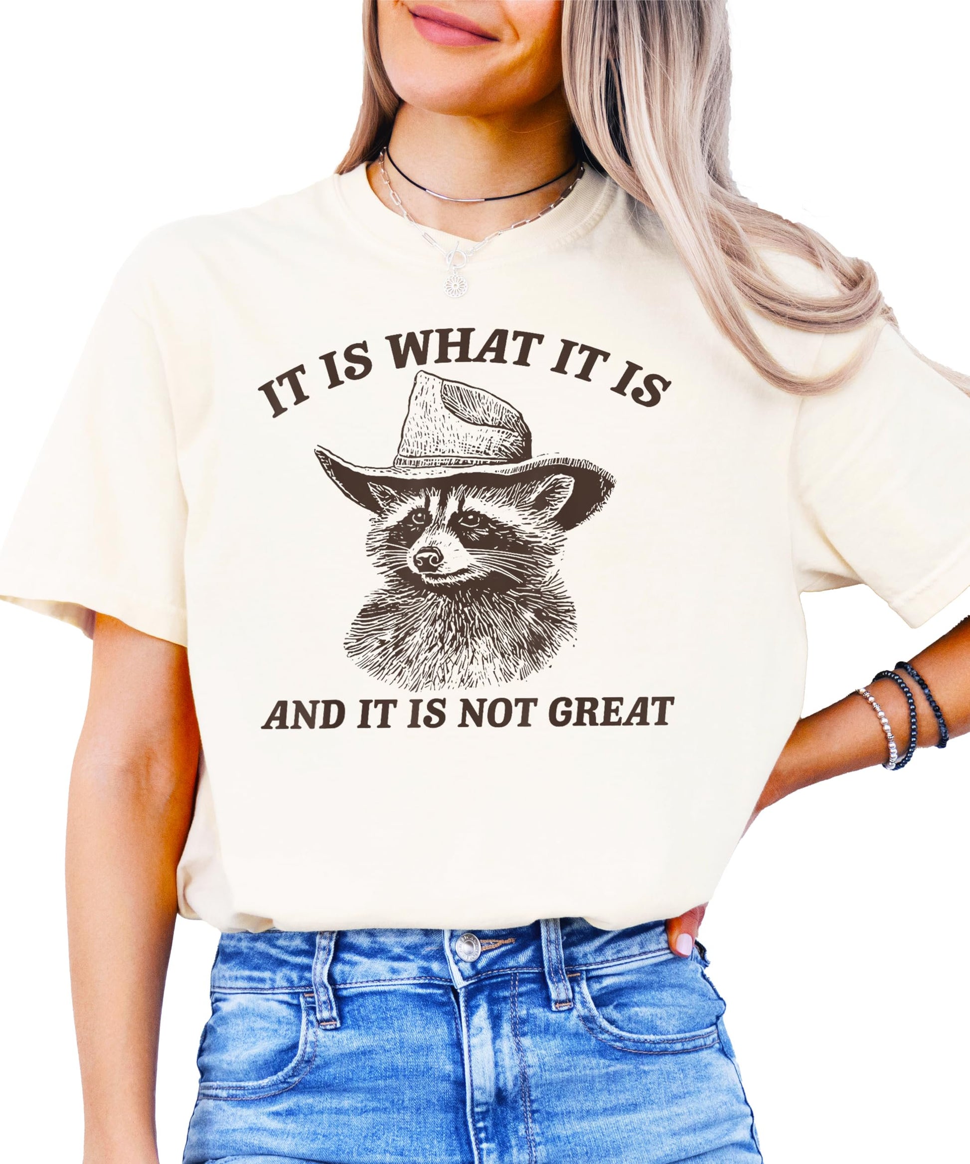 Detail shot of the high-quality screen print on the It Is What It Is raccoon tee in ivory