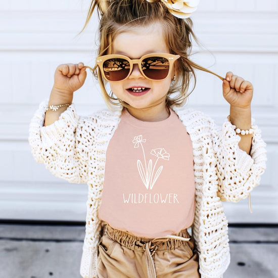 Detail view of white wildflower print on mauve mommy and me matching shirt