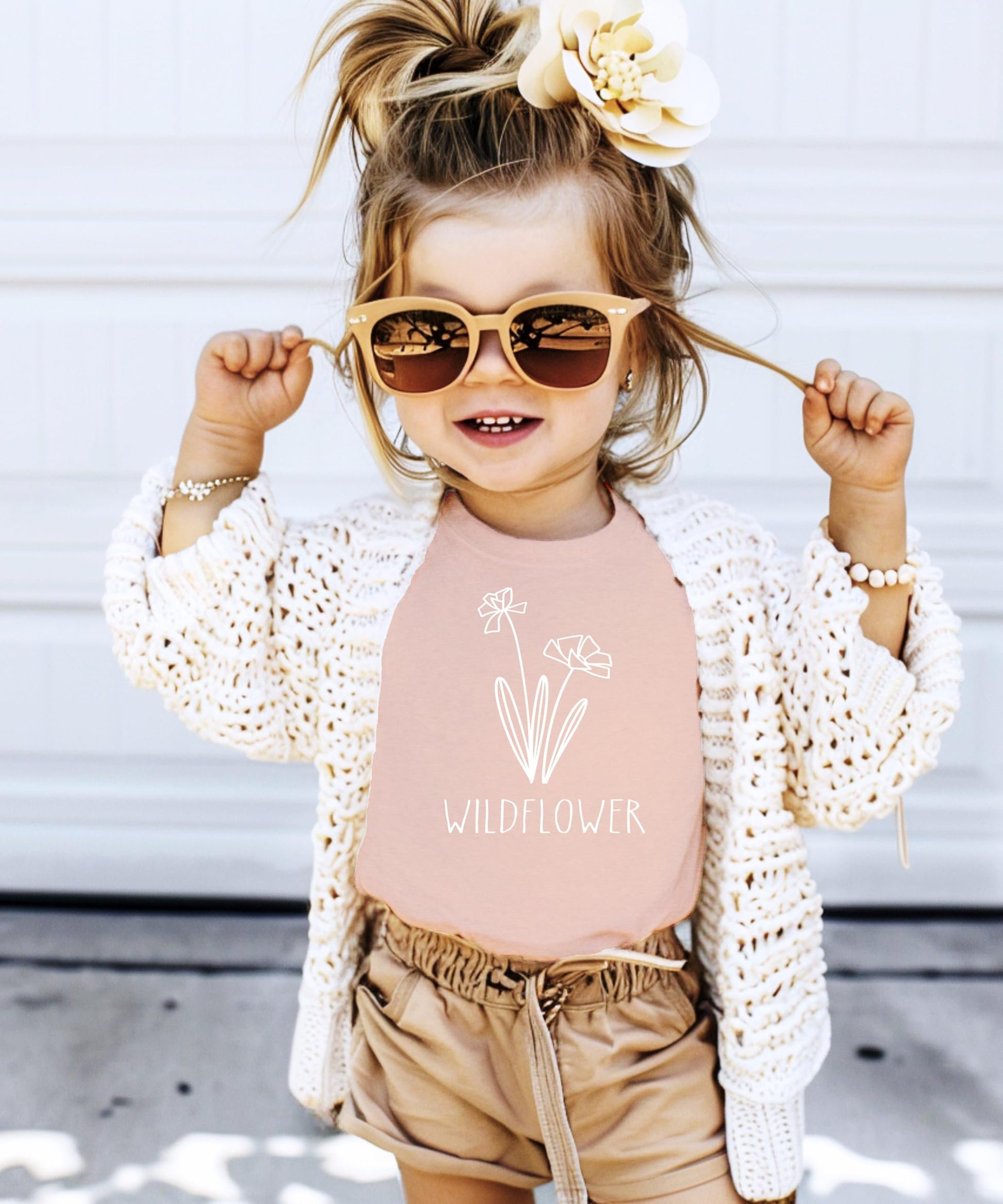 Detail view of white wildflower print on mauve mommy and me matching shirt