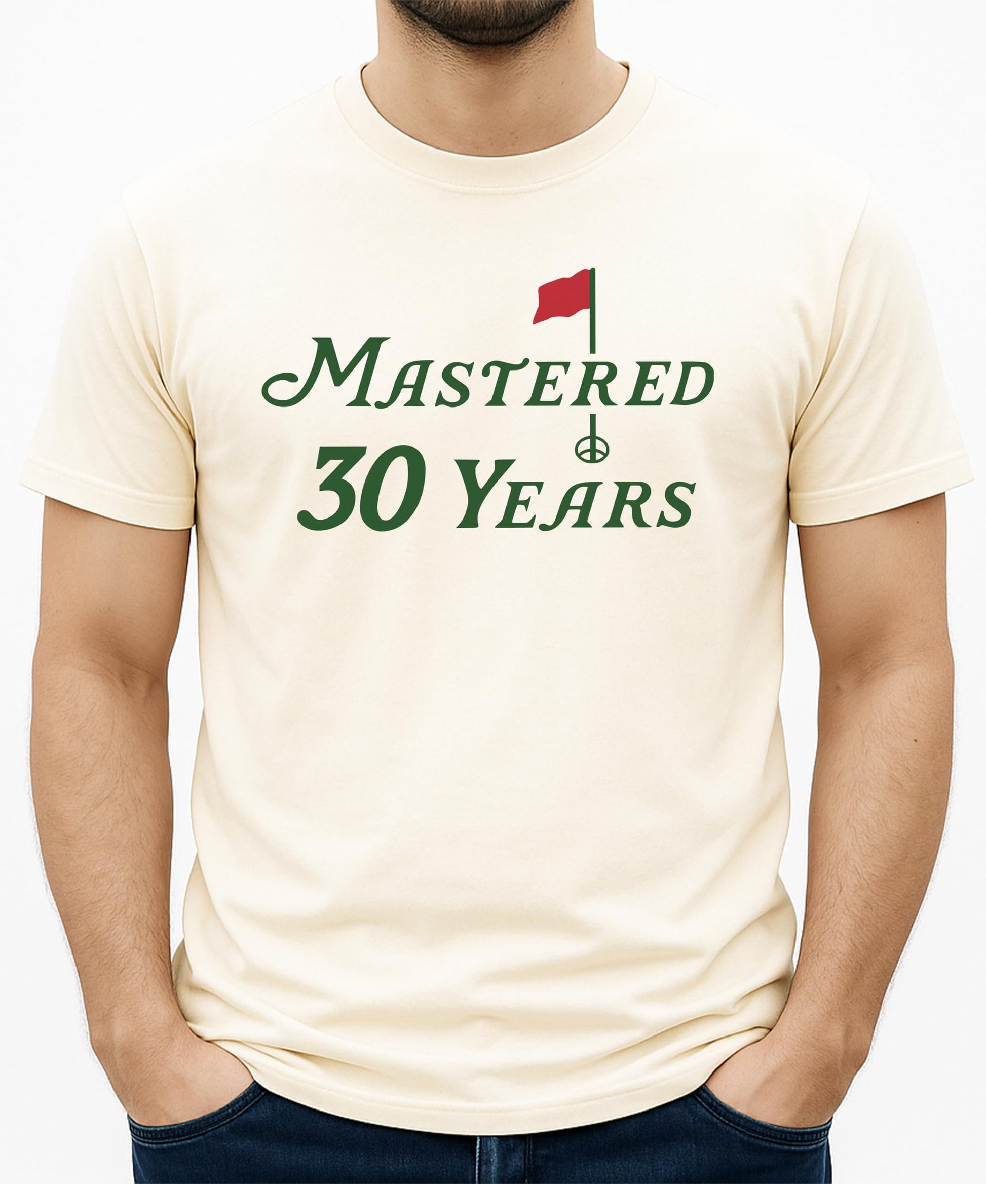 Mastered 30 Years unisex golf tee laid flat showing full shirt design and natural fabric color