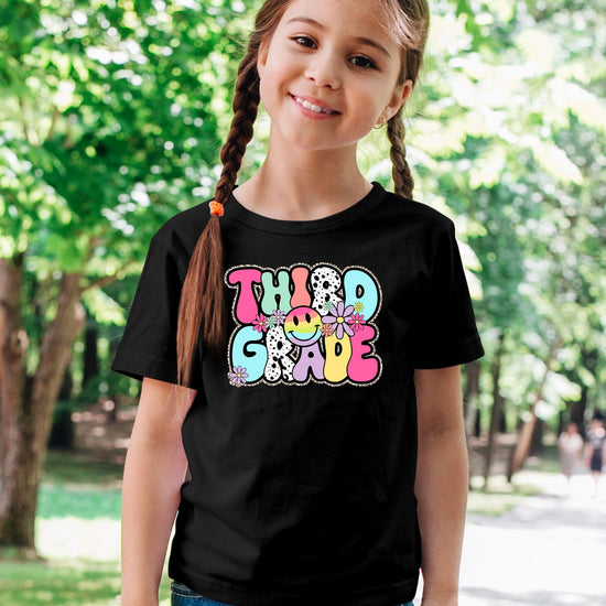 Detail shot of Third Grade retro print with colorful flowers and glitter effect on youth tee