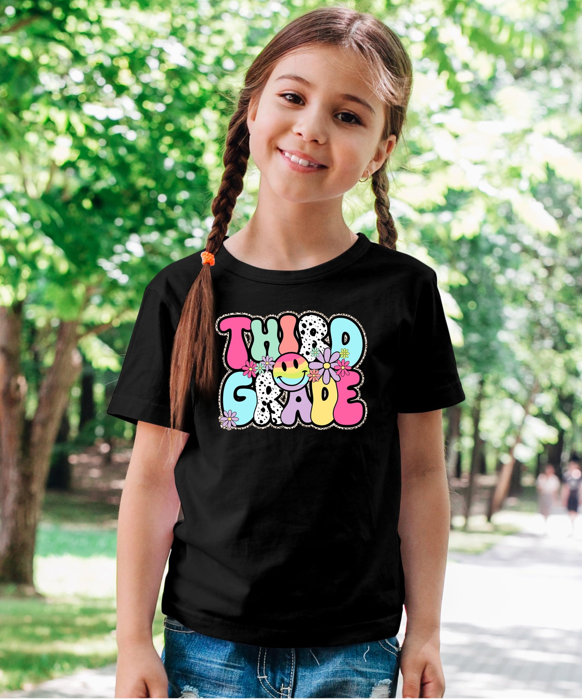 Detail shot of Third Grade retro print with colorful flowers and glitter effect on youth tee