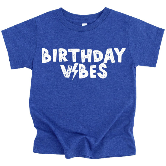 Toddler boy wearing Birthday Vibes lightning bolt birthday shirt in royal blue