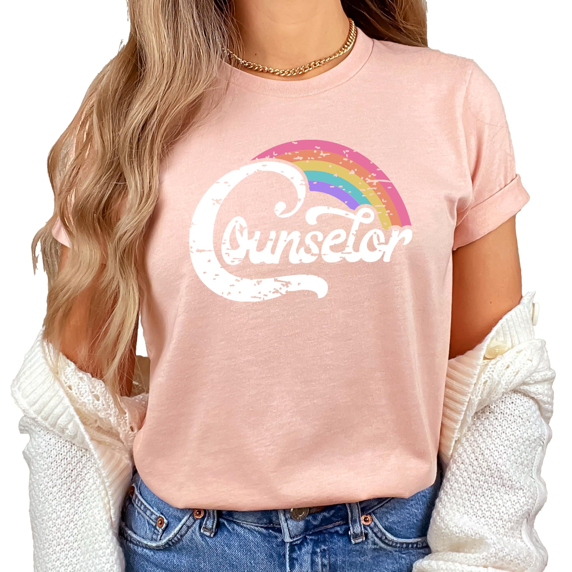 Close-up of vibrant rainbow counselor graphic print on black women's tee
