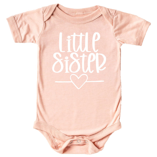 Baby girl wearing Little Sister Heart bodysuit in mauve with white graphic print