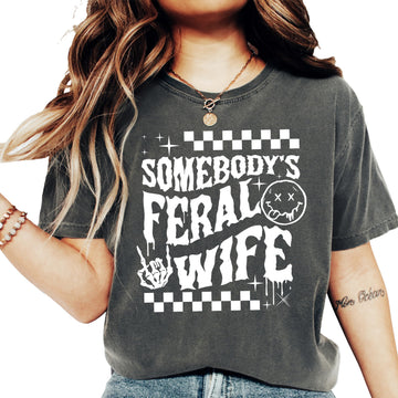 Close-up of Somebody's Feral Wife bold graphic print on women's tee
