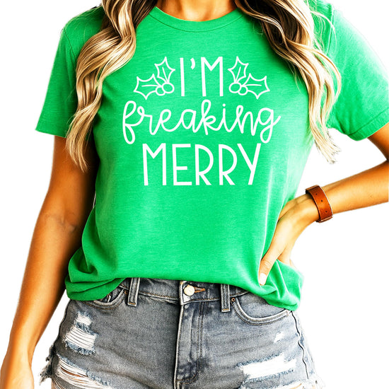 Front view of funny I'm Freaking Merry women's Christmas graphic tee in vintage green