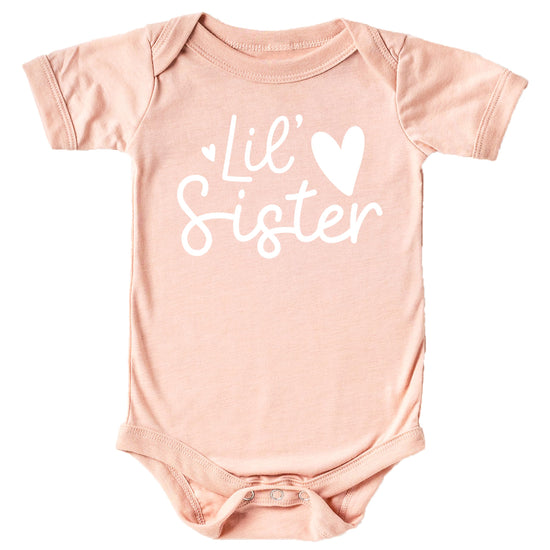 Mauve baby bodysuit with white Lil Sister heart graphic by Olive Loves Apple
