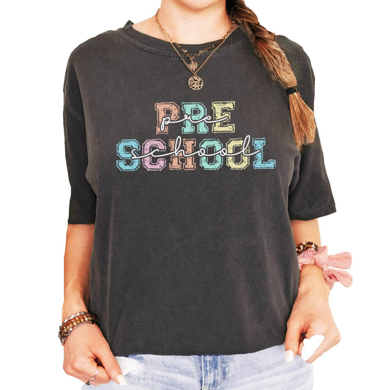 Preschool teacher women's graphic tee laid flat showing vibrant colorful font design