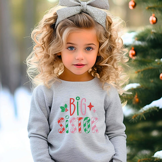 Detail shot of Big Sister Christmas sweatshirt print quality showing vibrant red, green, and pink candy cane design