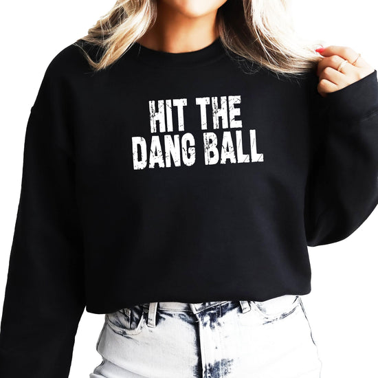 Front view of Hit The Dang Ball distressed graphic pullover sweatshirt in red for women and teens