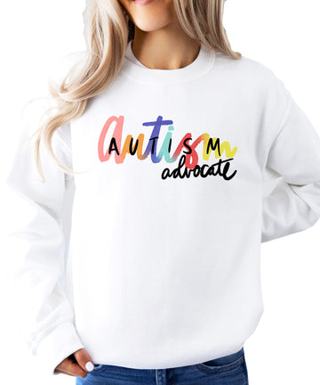 Close-up of vibrant Autism Advocate graphic print on a white women's sweatshirt