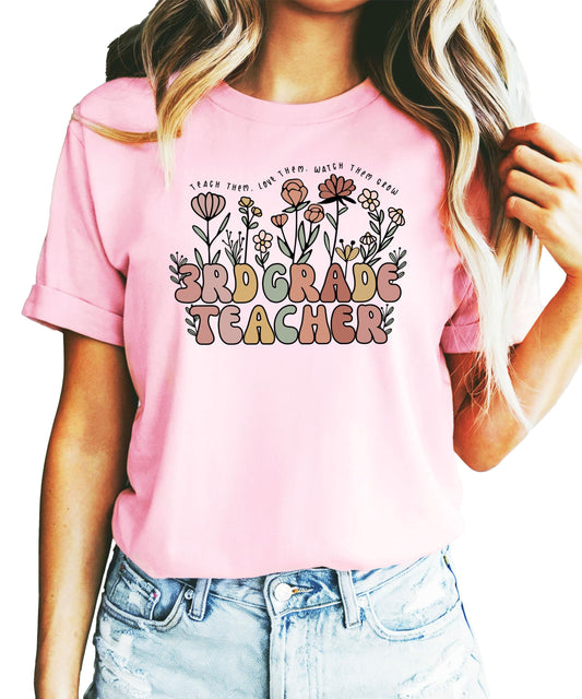 Women's 3rd grade teacher t-shirt with floral hand-drawn design and text Teach Them Love Them Watch Them Grow in peach