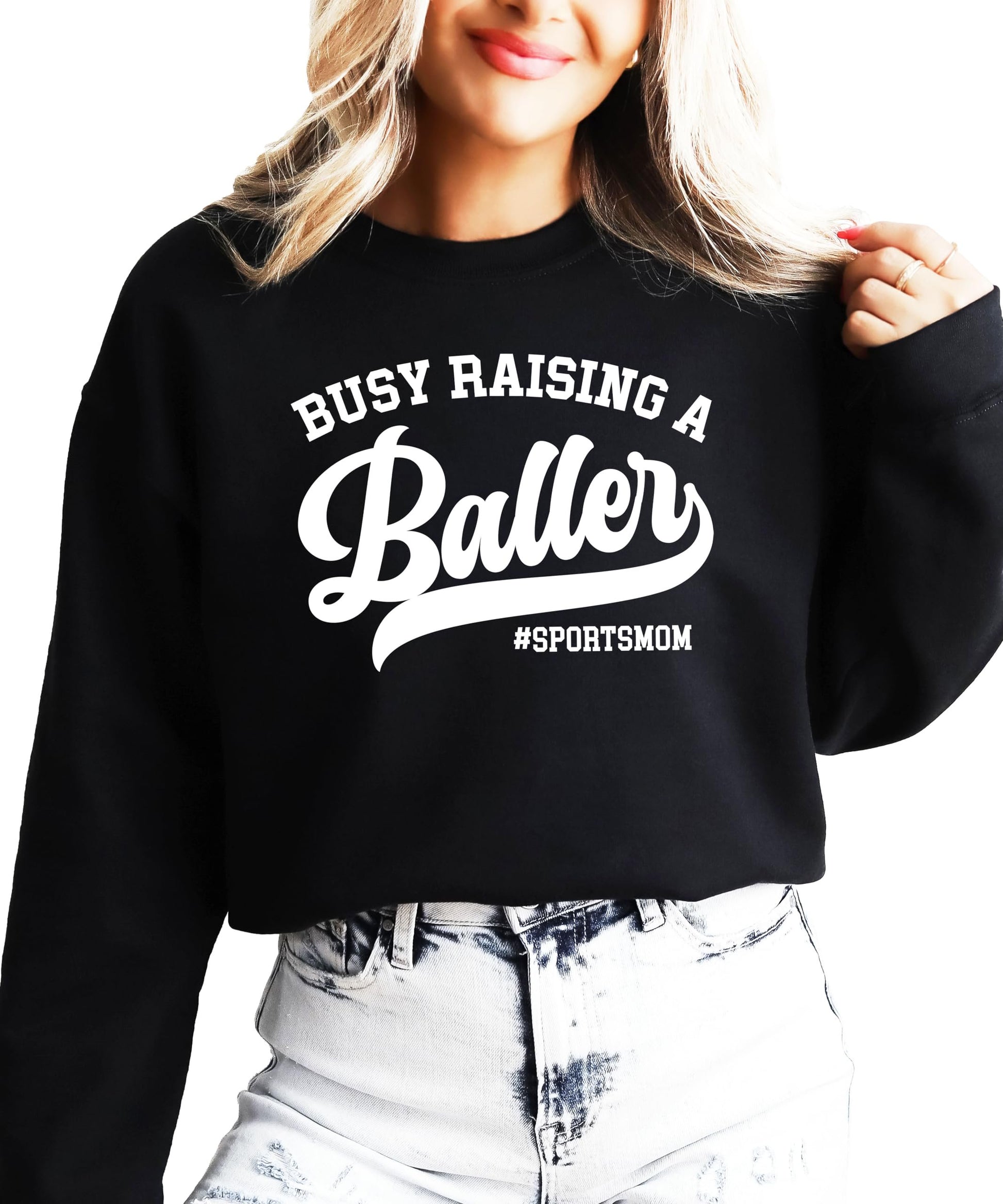 Close-up of Busy Raising a Baller graphic print detail on women's black sweatshirt