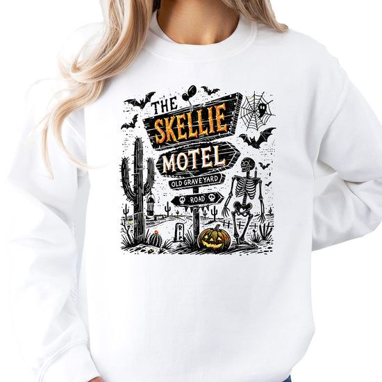 Flat lay of The Skellie Hotel Halloween sweatshirt for women men and youth by Olive Loves Apple