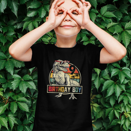 Detail shot of bold Birthday Boy dinosaur graphic on kids short sleeve tee