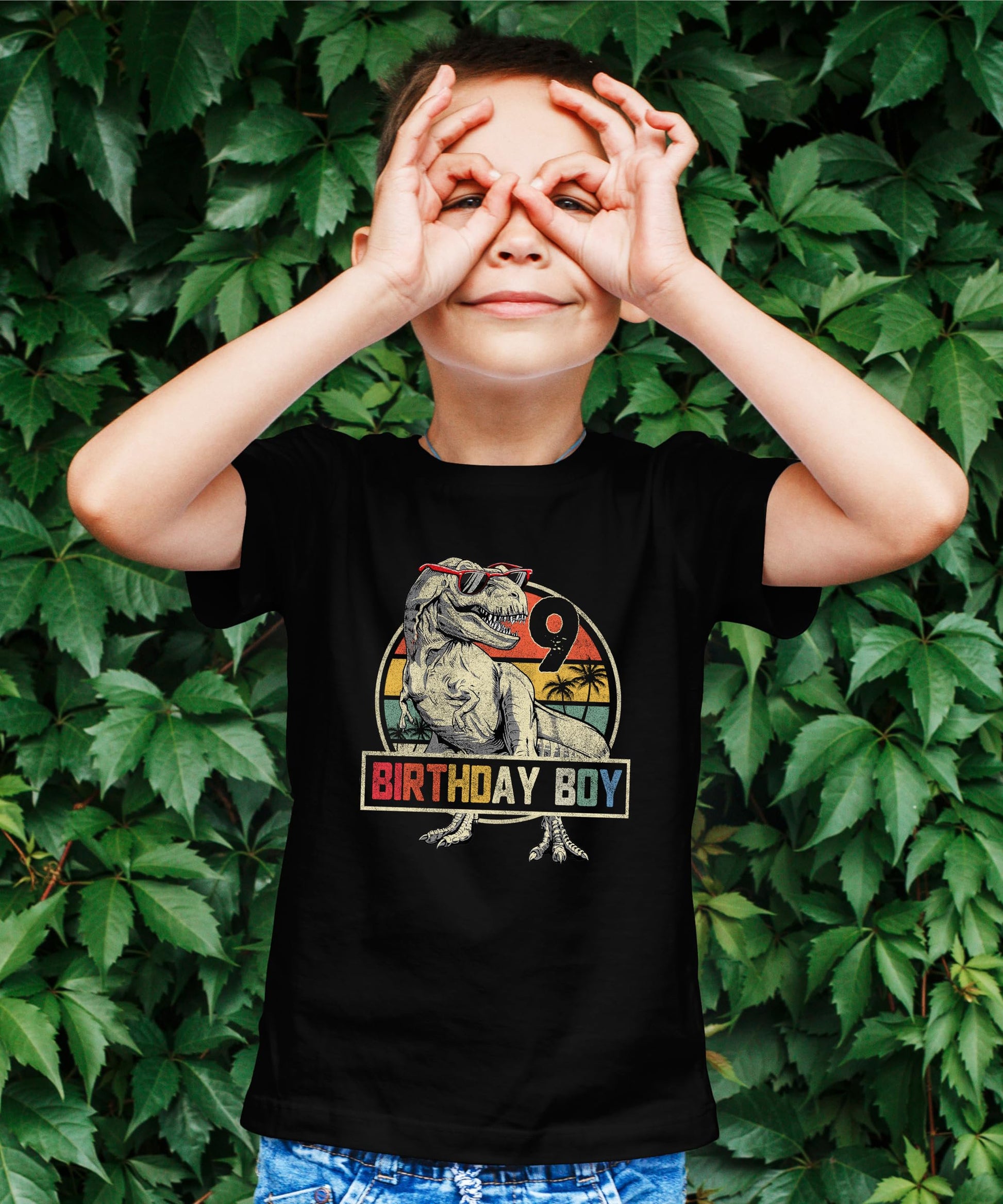 Detail shot of bold Birthday Boy dinosaur graphic on kids short sleeve tee