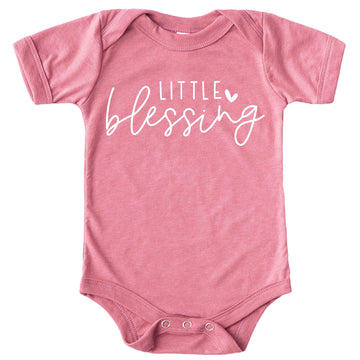 Peach newborn baby girl bodysuit with white Little Blessing heart graphic, laid flat