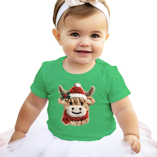 Detail shot of faux yarn style cow holiday print on kids red Christmas shirt