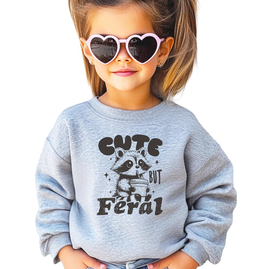 Side or alternate view of youth Cute But Feral raccoon sweatshirt showing fit and color