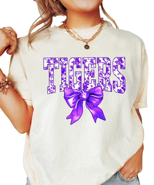 Close-up view of Tigers purple floral bow graphic on trendy shirt