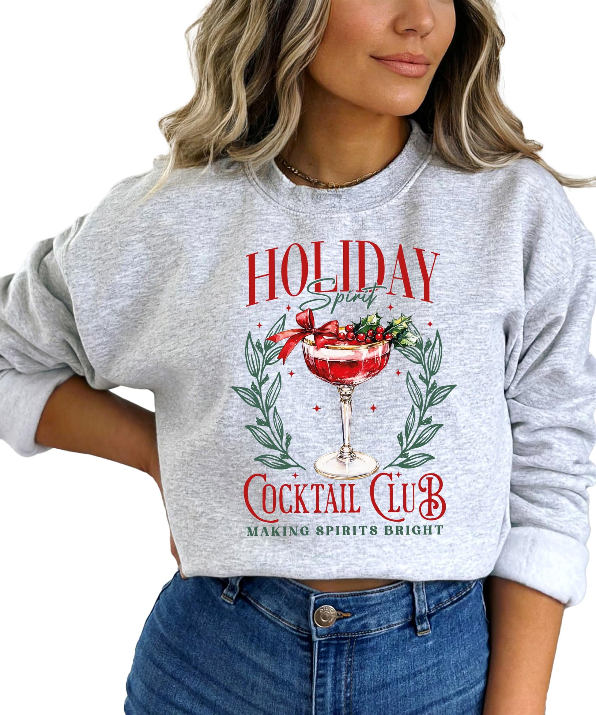 Lifestyle photo of women's funny Holiday Spirit Cocktail Club Christmas sweatshirt laid flat