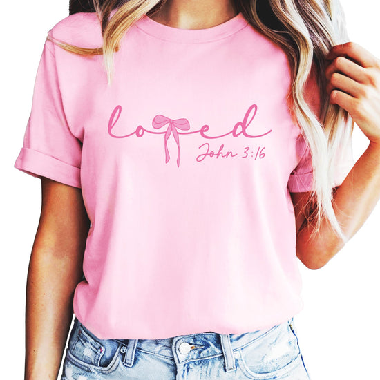 Teen girl wearing pink bow 'Loved' Christian Valentine's Day graphic tee