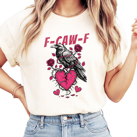 Close-up of crow and broken heart graphic print on ivory women's Valentine's Day tee