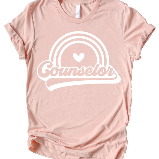 Women's retro rainbow counselor graphic tee in peach, perfect for back to school