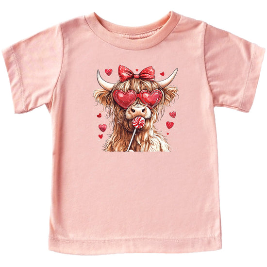 Young girl wearing cute pink Highland cow Valentine's Day graphic tee